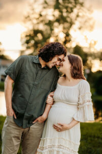 Husband and wife embrace each other while having maternity photos done in Hillsboro Missouri
