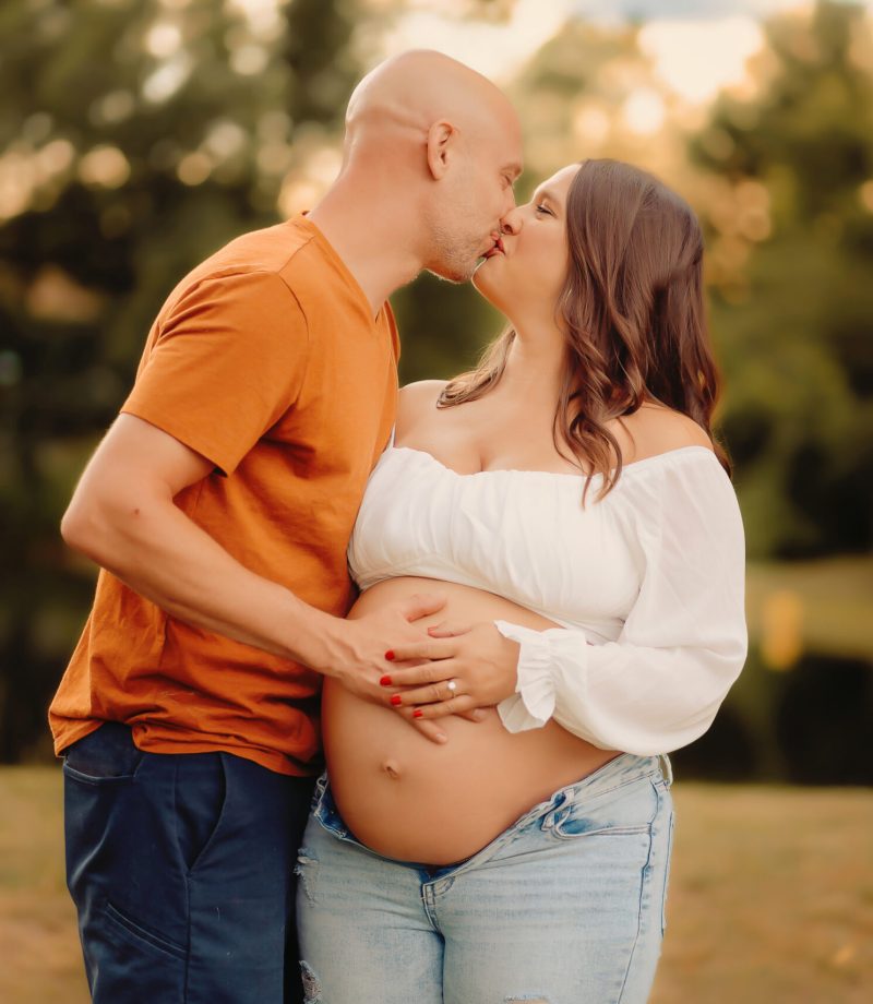 Couple kisses during their maternity photo session in Hillsboro Missouri
